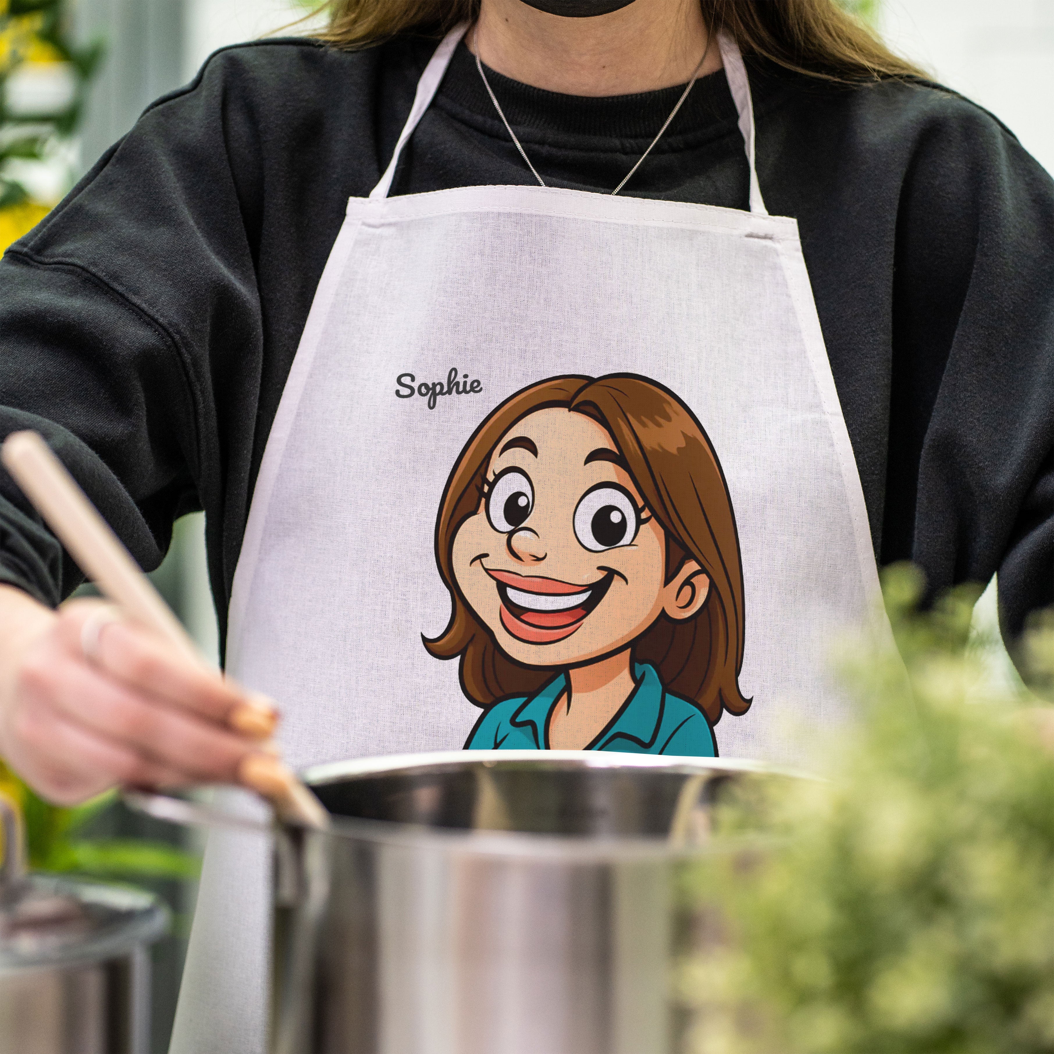 Karierte Schürze mit lustiger Karikatur und Text, ideal für Kinder, von kinder-druckerei.de, detailreiche Näharbeiten sichtbar