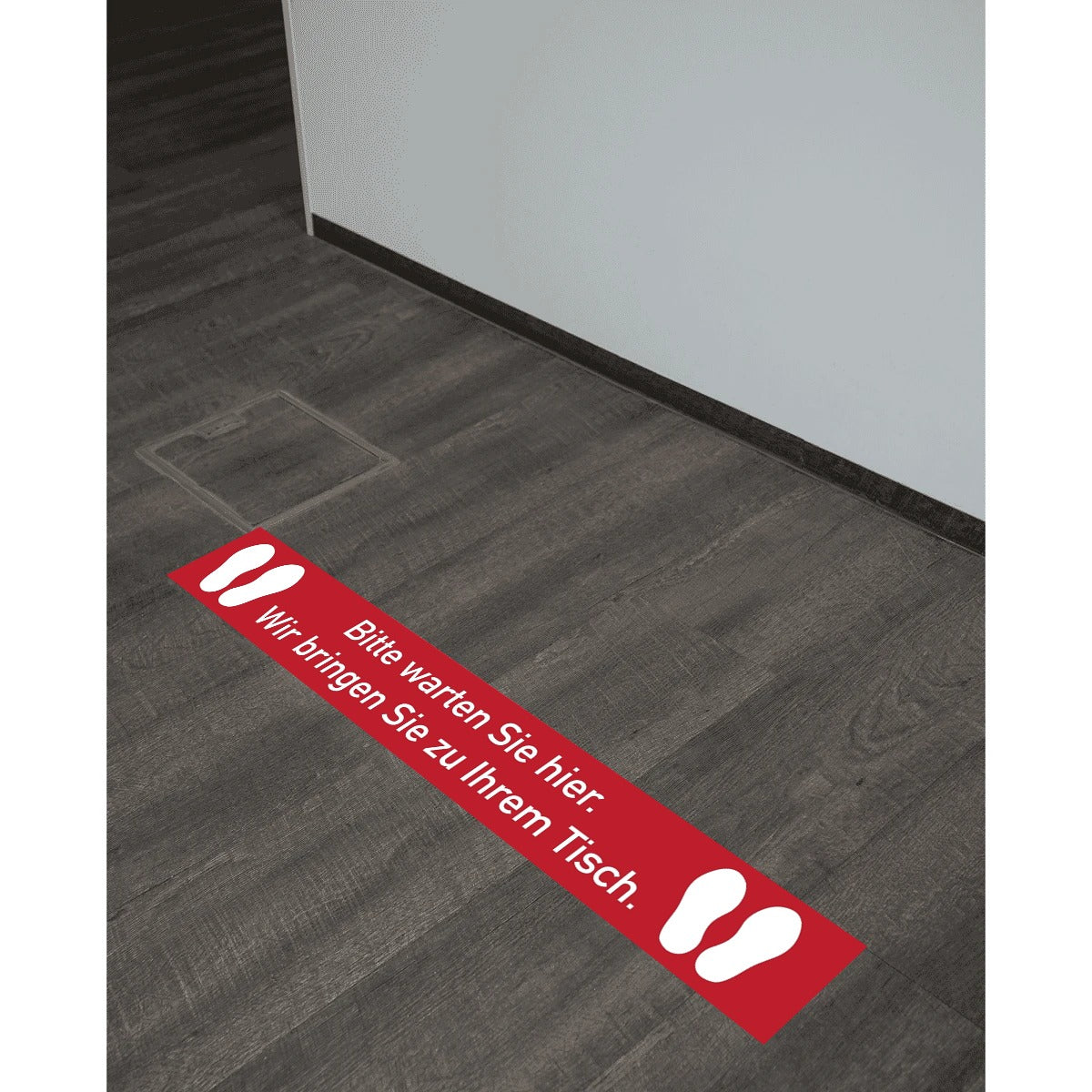 Roter Fußbodenaufkleber mit "Bitte warten Sie Hier" in 1000x150 mm, ideal für Wartebereiche, von aufkleberdrucker.de